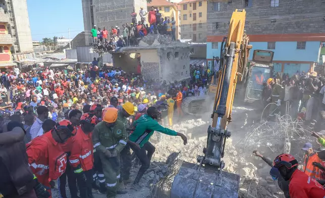Rescuers search for victims and survivors of a building collapse in Kenya's capital Nairobi, Monday, March 16, 2026. (AP Photo/Andrew Kasuku)