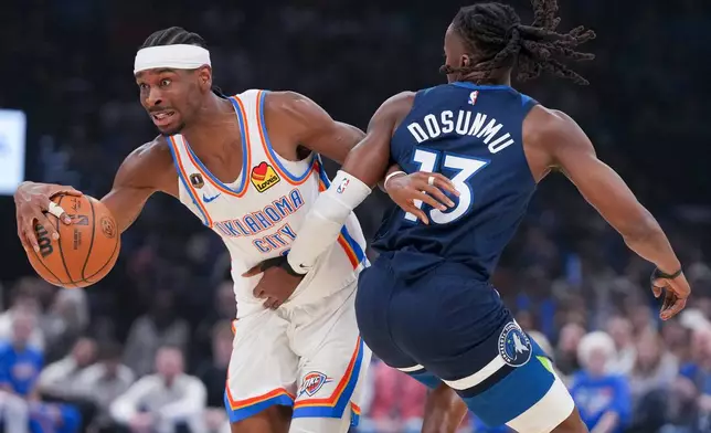 Oklahoma City Thunder Shai Gilgeous-Alexander, left, pushes past Minnesota Timberwolves guard Ayo Dosunmu, right, during the first half of an NBA basketball game, Sunday, March 15, 2026, in Oklahoma City. (AP Photo/Kyle Phillips)
