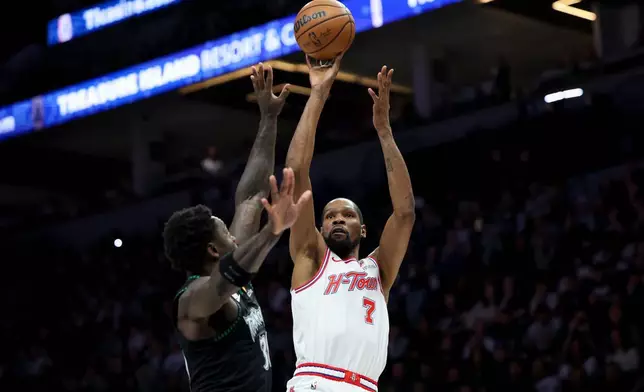 Houston Rockets forward Kevin Durant (7) shoots against Minnesota Timberwolves forward Julius Randle (30) during the first half of an NBA basketball game, Wednesday, March 25, 2026, in Minneapolis. (AP Photo/Ellen Schmidt)