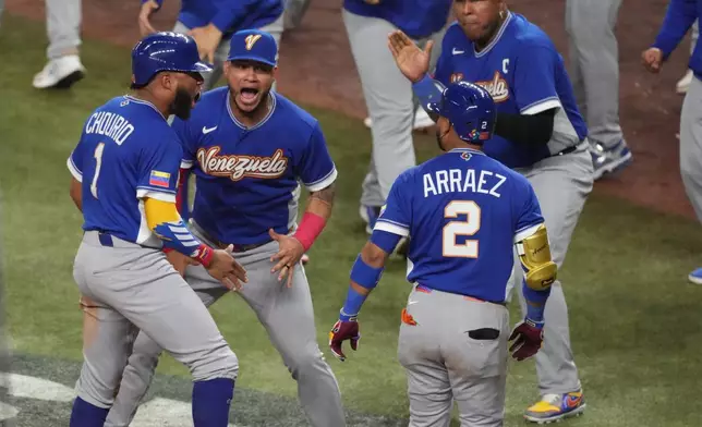 Venezuela Jackson Chourio (1) celebrates after scoring during the seventh inning of a World Baseball Classic semifinal game against Italy, Monday, March 16, 2026, in Miami. (AP Photo/Lynne Sladky)