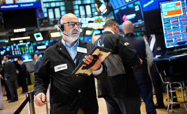 Federico DeMarco works on the floor at the New York Stock Exchange in New York, Wednesday, March 25, 2026. (AP Photo/Seth Wenig)