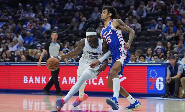 Memphis Grizzlies' Taylor Hendricks, left, tries to get a shot past Philadelphia 76ers' Dominick Barlow during the first half of an NBA basketball game, Tuesday, March 10, 2026, in Philadelphia. (AP Photo/Matt Rourke)