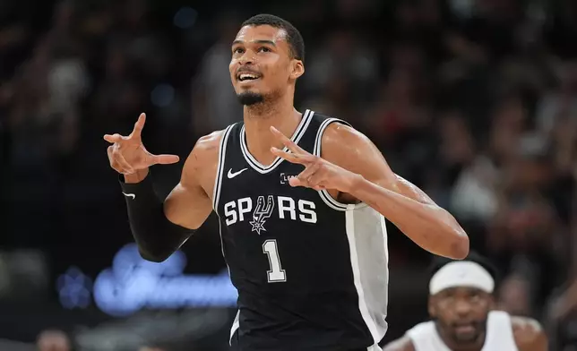 San Antonio Spurs forward Victor Wembanyama (1) reacts to a score against the Detroit Pistons during the first half of an NBA basketball game in San Antonio, Thursday, March 5, 2026. (AP Photo/Eric Gay)