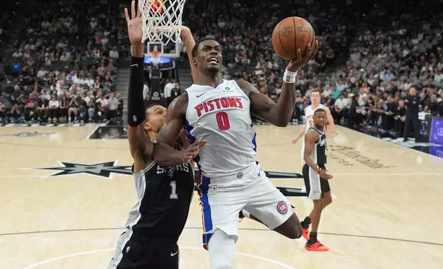 Detroit Pistons center Jalen Duren (0) drives to the basket against San Antonio Spurs forward Victor Wembanyama (1) during the first half of an NBA basketball game in San Antonio, Thursday, March 5, 2026. (AP Photo/Eric Gay)