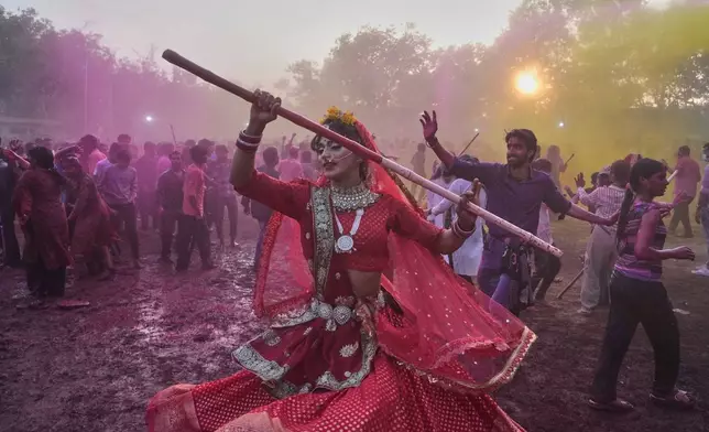 A member of transgender community dances during Holi festival celebrations at the Shri Krishna Janmabhoomi Temple complex in Mathura, India, on Feb. 27, 2026. (AP Photo/Manish Swarup)