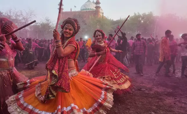 Members of transgender community dance during Holi festival celebrations at the Shri Krishna Janmabhoomi Temple complex in Mathura, India, on Feb. 27, 2026. (AP Photo/Manish Swarup)