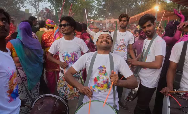 Revelers play drums at the Shri Krishna Janmabhoomi Temple complex during Holi festival celebrations in Mathura, India, on Feb. 27, 2026. (AP Photo/Manish Swarup)