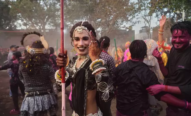 A transgender person participates along with others during Holi festival celebrations at the Shri Krishna Janmabhoomi Temple complex in Mathura, India, on Feb. 27, 2026. (AP Photo/Manish Swarup)