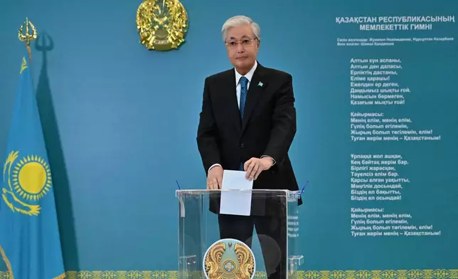 In this photo released by Kazakhstan's President Press Office, Kazakhstan's President Kassym-Jomart Tokayev casts his ballot at a polling station during a referendum on a new constitution, in Astana, Kazakhstan, Sunday, on Sunday, March 15, 2026. (Kazakhstan's President Press Office via AP)