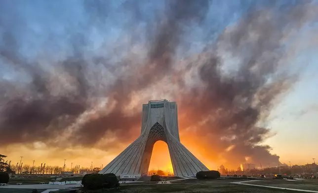 FILE - Smoke rises behind the Azadi (Freedom) monument in Tehran, Iran, on March 3, 2026, following the U.S.-Israeli military attack. (Davoud Ghahrdar/ISNA via AP, File)