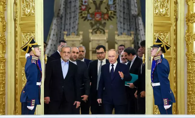 FILE - Iranian President Masoud Pezeshkian, center left, and Russian President Vladimir Putin, center right, arrive at a ceremony following their talks at the Kremlin in Moscow, Russia, on Jan. 17, 2025. (Vyacheslav Prokofyev, Sputnik, Kremlin Pool Photo via AP, File)