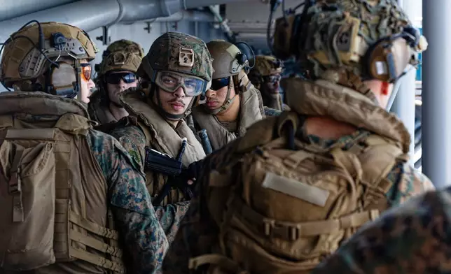 This image from video provided by U.S. Central Command shows U.S. Sailors and Marines aboard USS Tripoli (LHA 7) arriving in the U.S. Central Command area of responsibility, March 27, 2026. (U.S. Central Command via AP)
