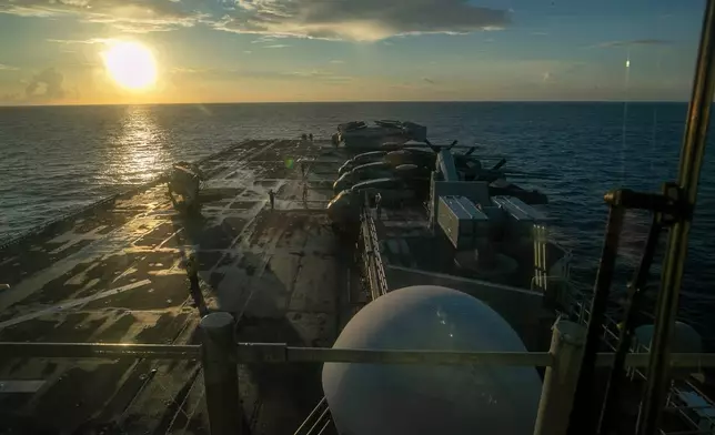 This image from video provided by U.S. Central Command shows U.S. Sailors and Marines aboard USS Tripoli arriving in the U.S. Central Command area of responsibility, March 27, 2026. (U.S. Central Command via AP)