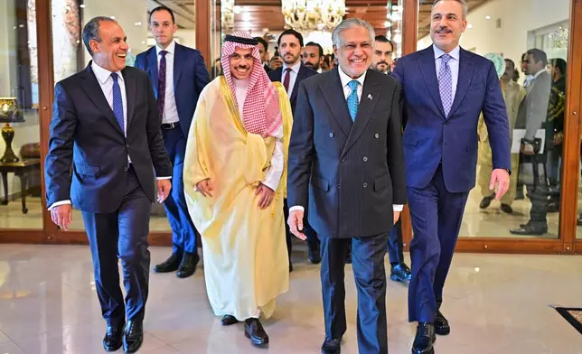 In this photo released by the Pakistan Ministry of Foreign Affairs, from left, Egyptian Foreign Minister Badr Abdelatty, Saudi Arabia's Foreign Minister Prince Faisal bin Farhan Al-Saud, Pakistan's Foreign Minister Ishaq Dar and Turkish Foreign Minister Hakan Fidan walk prior to their meeting to discuss the Middle East war, in Islamabad, Pakistan, Sunday, March 29, 2026. (Pakistan Ministry of Foreign Affairs via AP)