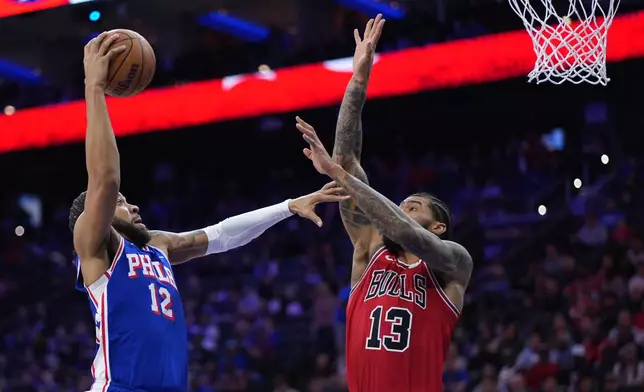 Philadelphia 76ers' Trendon Watford, left, goes up for a shot against Chicago Bulls' Nick Richards during the first half of an NBA basketball game Wednesday, March 25, 2026, in Philadelphia. (AP Photo/Matt Slocum)