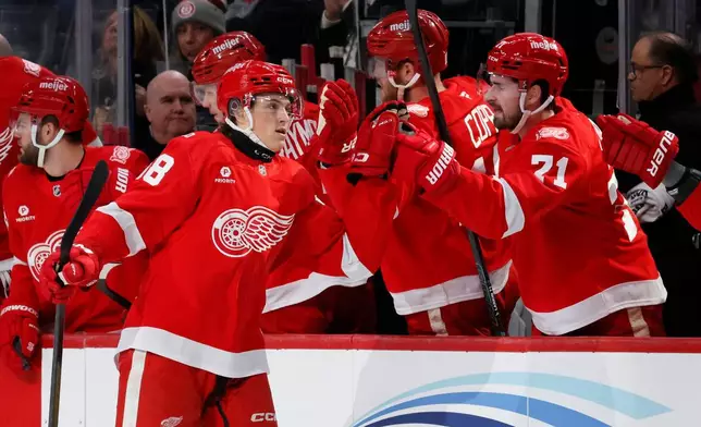 Detroit Red Wings center Emmitt Finnie, left, celebrates with teammates after scoring against the Vegas Golden Knights during the first period of an NHL hockey game Wednesday, March 4, 2026, in Detroit. (AP Photo/Duane Burleson)