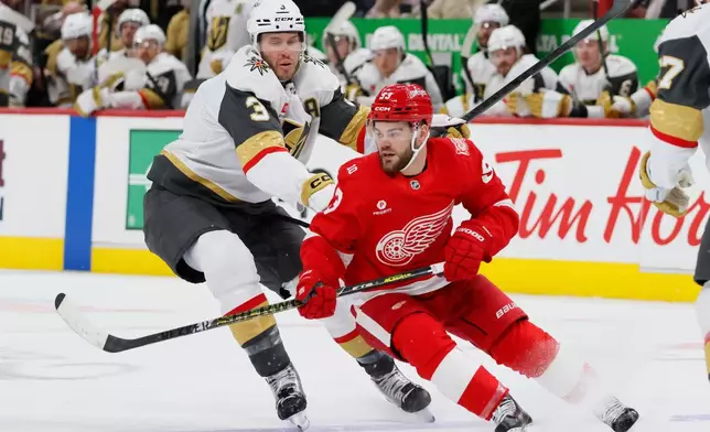 Detroit Red Wings right wing Alex DeBrincat (93) is pushed by Vegas Golden Knights defenseman Brayden McNabb (3) during the second period of an NHL hockey game Wednesday, March 4, 2026, in Detroit. (AP Photo/Duane Burleson)
