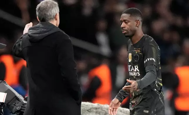 PSG's Ousmane Dembele, right, leaves the pitch and speaks with PSG's head coach Luis Enrique after being substituted during the first leg of the Champions League round of 16 soccer match between Paris Saint-Germain and Chelsea, in Paris, Wednesday, March 11, 2026. (AP Photo/Michel Euler)