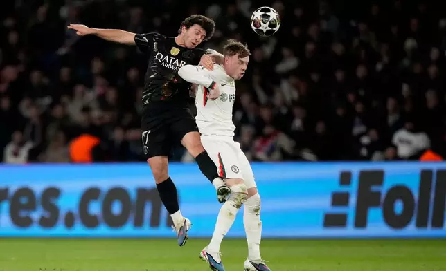 PSG's Joao Neves, left, and Chelsea's Cole Palmer challenge for the ball during the first leg of the Champions League round of 16 soccer match between Paris Saint-Germain and Chelsea, in Paris, Wednesday, March 11, 2026. (AP Photo/Michel Euler)