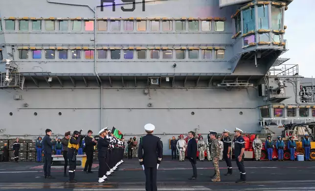 French President Emmanuel Macron, center right, visits the French aircraft carrier Charles de Gaulle, during his visit to Cyprus, Monday March 9, 2026. (Gonzalo Fuentes/Pool Photo via AP)