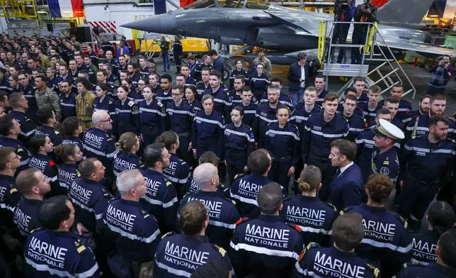 French President Emmanuel Macron meets the crew as he visits the French aircraft carrier Charles de Gaulle, during his visit to Cyprus, Monday March 9, 2026. (Gonzalo Fuentes/Pool Photo via AP)