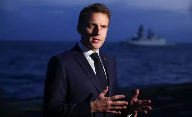 French President Emmanuel Macron speaks to members of the media as he visits the French aircraft carrier Charles de Gaulle, during his visit to Cyprus, Monday March 9, 2026. (Gonzalo Fuentes/Pool Photo via AP)