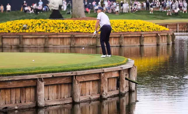 Austin Smotherman putts on the 17th green during the first round of The Players Championship golf tournament Thursday, March 12, 2026, in Ponte Bedra Beach, Fla. (AP Photo/Gerald Herbert)