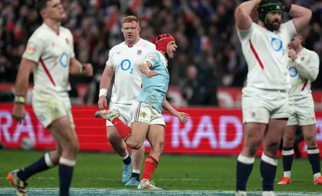 Louis Bielle‑Biarrey of France celebrates after Thomas Ramos kicked the winning penalty during the Six Nations rugby union match between France and England in Saint-Denis, outside Paris, Saturday, March 14, 2026. (AP Photo/Michel Euler)