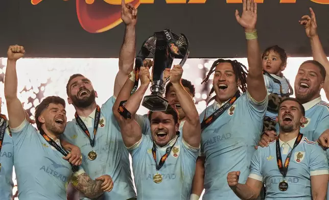 Antoine Dupont of France holds the trophy aloft after clinching the title after winning the Six Nations rugby union match between France and England in Saint-Denis, outside Paris, Saturday, March 14, 2026. (AP Photo/Michel Euler)
