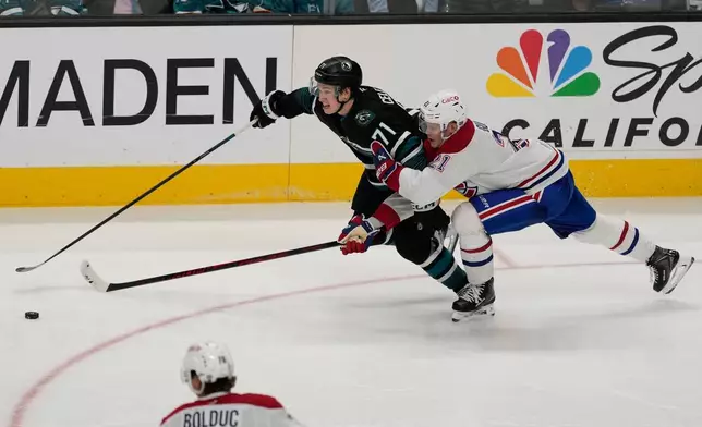 San Jose Sharks center Macklin Celebrini (71) skates with the puck against Montréal Canadiens defenseman Kaiden Guhle (21) during the third period of an NHL hockey game in San Jose, Calif., Tuesday, March 3, 2026. (AP Photo/Jeff Chiu)
