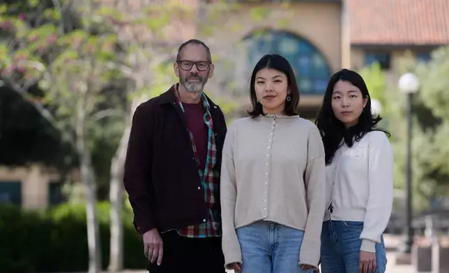 Dan Jurafsky, Stanford professor of computer science and linguistics, from left, Myra Cheng, Stanford Ph.D. candidate in computer science, and Cinoo Lee, Stanford postdoctoral fellow in psychology, pose for photos on the university campus in Stanford, Calif., Thursday, March 26, 2026. (AP Photo/Jeff Chiu)