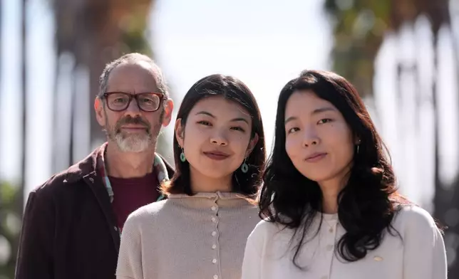 Dan Jurafsky, Stanford professor of computer science and linguistics, from left, Myra Cheng, Stanford Ph.D. candidate in computer science, and Cinoo Lee, Stanford postdoctoral fellow in psychology, pose for photos on the university campus in Stanford, Calif., Thursday, March 26, 2026. (AP Photo/Jeff Chiu)