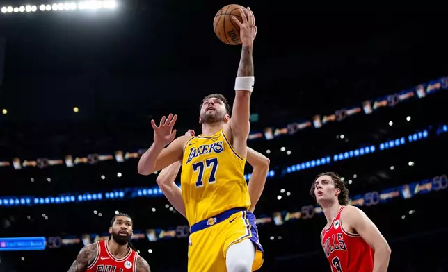 Los Angeles Lakers guard Luka Doncic (77) goes to the basket against the Chicago Bulls during the first half of an NBA basketball game against the Chicago Bulls, Thursday, March 12, 2026, in Los Angeles. (AP Photo/Ethan Swope)