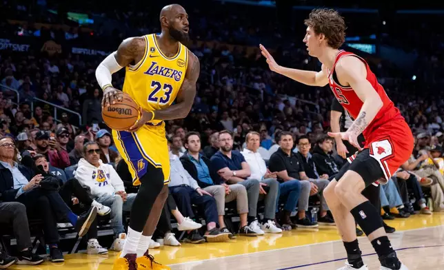 Los Angeles Lakers forward LeBron James (23) is defended during the first half of an NBA basketball game against the Chicago Bulls, Thursday, March 12, 2026, in Los Angeles. (AP Photo/Ethan Swope)