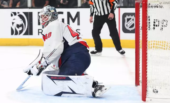 Washington Capitals goaltender Logan Thompson (48) fails to stop a shot against the Vegas Golden Knights during the second period of an NHL hockey game Saturday, March 28, 2026, in Las Vegas. (AP Photo/Ian Maule)