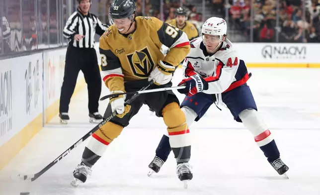 Vegas Golden Knights right wing Mitch Marner (93) skates against Washington Capitals defenseman Cole Hutson (44) during the second period of an NHL hockey game Saturday, March 28, 2026, in Las Vegas. (AP Photo/Ian Maule)
