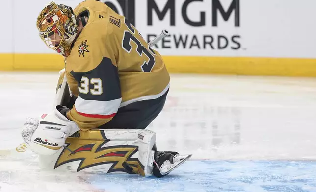 Vegas Golden Knights goaltender Adin Hill makes a save against the Washington Capitals during the first period of an NHL hockey game Saturday, March 28, 2026, in Las Vegas. (AP Photo/Ian Maule)
