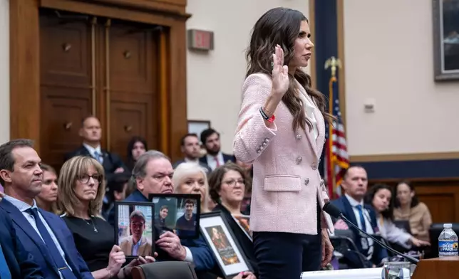Bryon Norm, left, watches as his wife, Homeland Security Secretary Kristi Noem, as she is sworn in before testifying in front of a House Judiciary Committee hearing on the oversight of the Department of Homeland Security, Wednesday, March 4, 2026 in Washington. (AP Photo/Kevin Wolf)