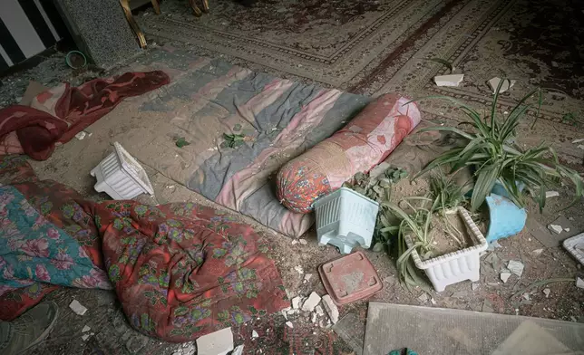 A damaged room is seen in a house that was affected when a nearby residential building was hit in an overnight strike during the U.S.-Israeli military campaign in Tabriz, East Azerbaijan Province, northwestern Iran, Tuesday, March 24, 2026. (AP Photo/Matin Hashemi)