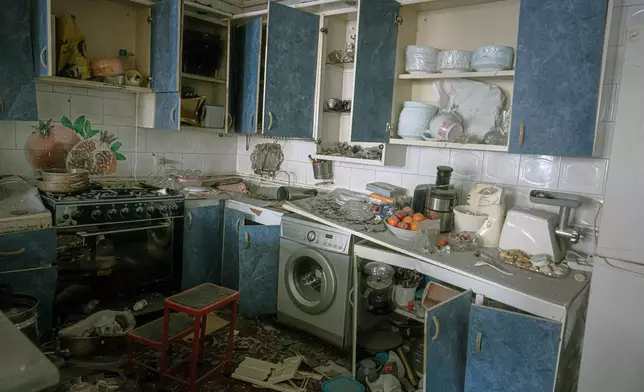 A damaged kitchen is seen in a house that was affected when a nearby residential building was hit in an overnight strike during the U.S.-Israeli military campaign in Tabriz, East Azerbaijan Province, northwestern Iran, Tuesday, March 24, 2026. (AP Photo/Matin Hashemi)
