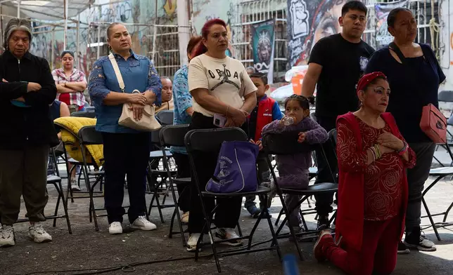 Parishioners pray to a giant Baby Jesus in Mexico City, Tuesday, March 10, 2026. (AP Photo/Ginnette Riquelme)