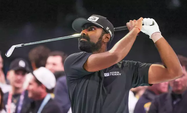 Sahith Theegala hits a practice iron before the TGL finals golf tournament in Palm Beach Gardens, Fla., Tuesday, March 24, 2026. (AP Photo/Reinhold Matay)