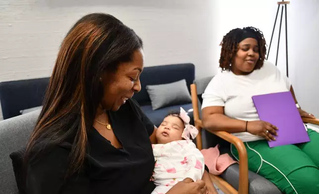 Mary Bey looks on while doula Shanille Bowens holds Bey's daughter, Ca'Mya, during an appointment on Feb. 28, 2026, in Memphis, Tenn. (AP Photo/Kristin M. Hall)