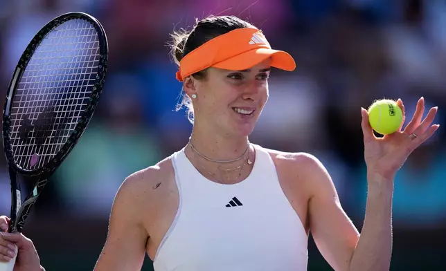 Elina Svitolina, of Ukraine, reacts after winning a game against Iga Swiatek, of Poland, during a quarterfinal match at the BNP Paribas Open tennis tournament, Thursday, March 12, 2026, in Indian Wells, Calif. (AP Photo/Mark J. Terrill)