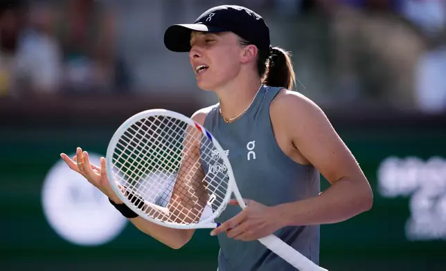 Iga Swiatek, of Poland, reacts after losing a point against Elina Svitolina, of Ukraine, during a quarterfinal match at the BNP Paribas Open tennis tournament, Thursday, March 12, 2026, in Indian Wells, Calif. (AP Photo/Mark J. Terrill)