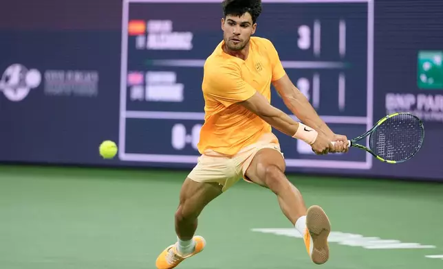 Carlos Alcaraz, of Spain, returns a shot against Cameron Norrie, of Britain, during a quarterfinal match at the BNP Paribas Open tennis tournament, Thursday, March 12, 2026, in Indian Wells, Calif. (AP Photo/Mark J. Terrill)