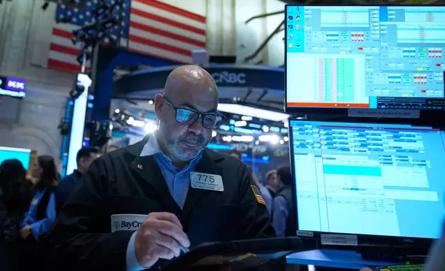 Federico DeMarco works on the floor at the New York Stock Exchange in New York, Tuesday, March 10, 2026. (AP Photo/Seth Wenig)
