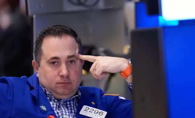 Gennaro Saporito works on the floor at the New York Stock Exchange in New York, Friday, March 6, 2026. (AP Photo/Seth Wenig)
