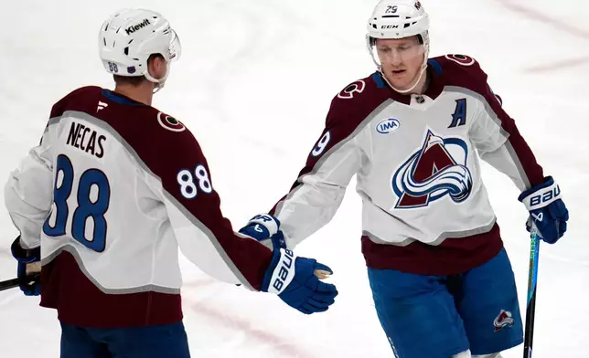 Colorado Avalanche's Nathan MacKinnon (29) celebrates with Martin Necas after scoring during the first period of an NHL hockey game against the Pittsburgh Penguins in Pittsburgh, Tuesday, March 24, 2026. (AP Photo/Gene J. Puskar)