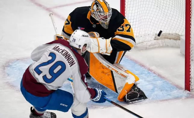 Colorado Avalanche's Nathan MacKinnon (29) puts a shot behind Pittsburgh Penguins goaltender Arturs Silovs (37) for a goal during the first period of an NHL hockey game in Pittsburgh, Tuesday, March 24, 2026. (AP Photo/Gene J. Puskar)